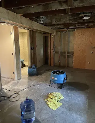 Room opened to the ceiling joists with an air mover running in Brentwood, TN