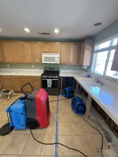 Kitchen with a dehumidifier and air movers set on the tile in Brentwood, TN