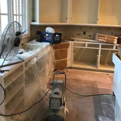 Kitchen cabinets wrapped in plastic with a fan drying the space in Brentwood, TN